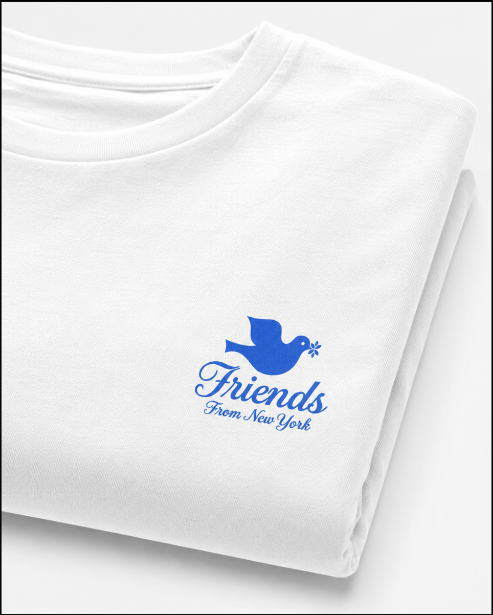 Folded white Friends From New York T-shirt with a blue dove and script logo printed on the left chest.